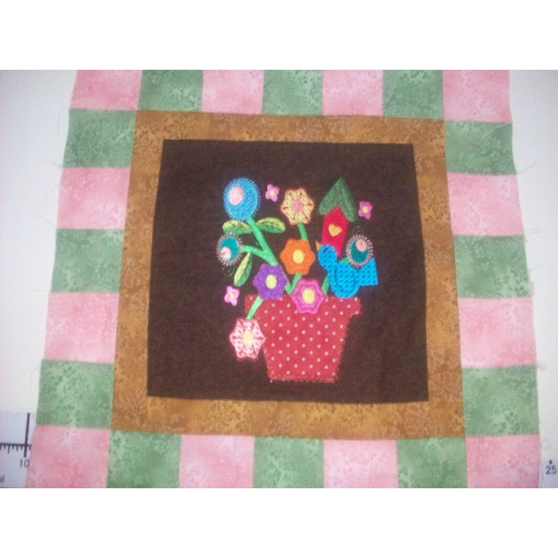 Potted Flowers machine embroidered on center block in 14 inch quilt block - My wife's work