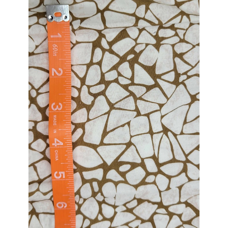 White pebbles on tan background 12" x wof